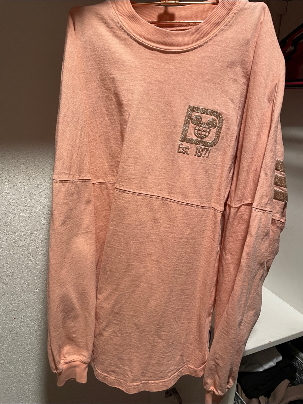 Disney Parks peach long sleeve spirit jersey with gold glitter logo